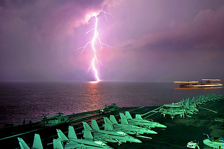 white fighter planes near lightning during night time thumbnail