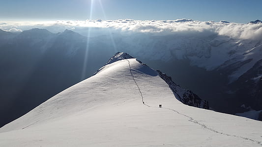 mountain covered by snow during daytime thumbnail