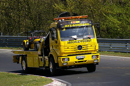 yellow Mercedes-Benz truck speeding on roadf thumbnail