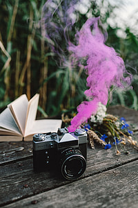Colorful smoke bomb, book and vintage camera thumbnail