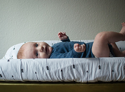 toddler lying on rectangular white and black reversible mat thumbnail