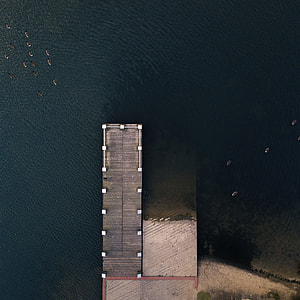 gray wooden dock aerial photography thumbnail