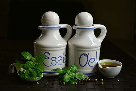 two white ceramic jars beside bowl thumbnail