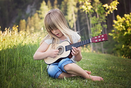 girl playing of beige guitar thumbnail