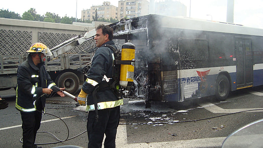 two firemen near burning bus thumbnail