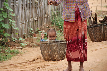 toddler inside brown wicker basket thumbnail