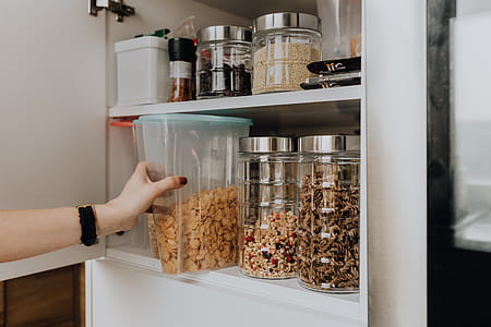 Containers of cereals in kitchen cupboard thumbnail