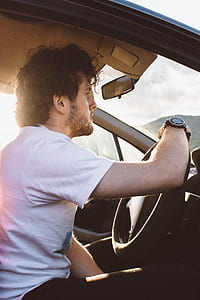 man sitting inside the car during daytime thumbnail