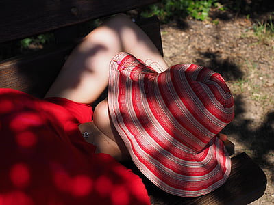 person face covered with sun hat thumbnail
