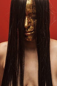 woman with gold colored mask while topless thumbnail