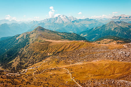 aerial photo of brown and green mountain range under clear sky thumbnail