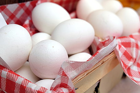 shallow focus photography of chicken eggs in wicker basket thumbnail