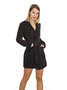 woman inserting both hands in black trench coat pockets thumbnail