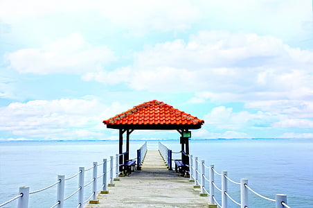red and black wooden kiosk on dock at daytime thumbnail