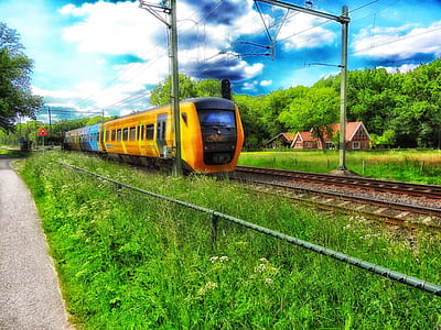 orange and black train on rail thumbnail