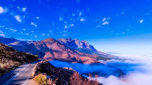 brown mountain beside white fog thumbnail