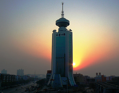 Tower in front of the setting sun in Tianjin, China thumbnail