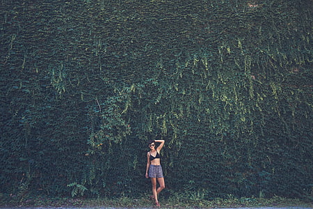 woman standing beside plants thumbnail