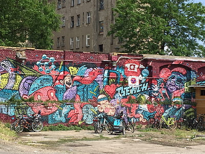 long-angle photography of graffiti wall by day thumbnail