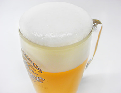 beer glass with yellow liquid and white foam thumbnail