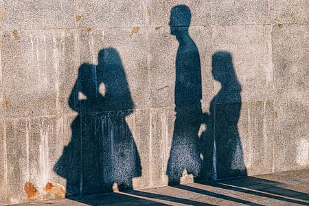 shadow of four persons on wall thumbnail