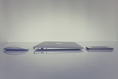 Silver Magic Mouse Beside Macbook thumbnail