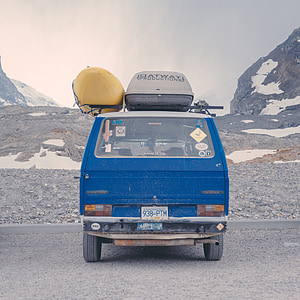 blue vehicle with yellow kayak on top at daytime thumbnail