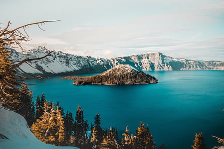 island with trees and mountain at daytime thumbnail