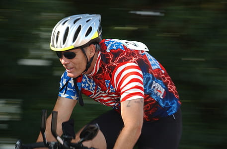 photo of a man riding bicycle during daytime thumbnail