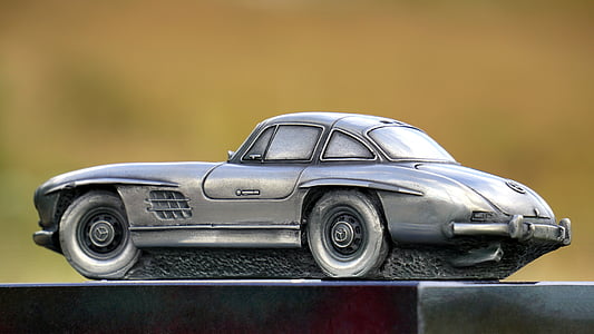 gray die-cast coupe on black surface thumbnail