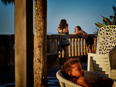 two women standing on balcony thumbnail