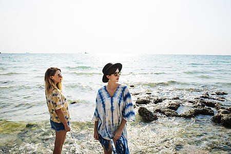 two women standing on beach thumbnail