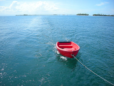 red boat on body of water thumbnail