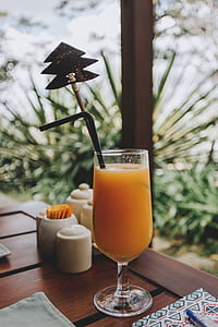 orange juice with black straw thumbnail