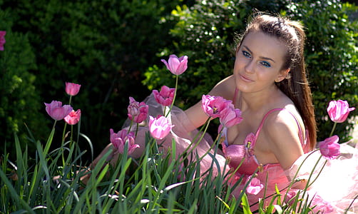 woman near pink flowers during daytime thumbnail