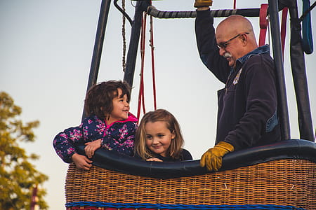 Man and Two Girls Riding on Hot Air Balloon thumbnail