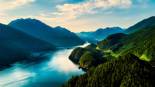 aerial photography of mountain and body of water during daytime thumbnail