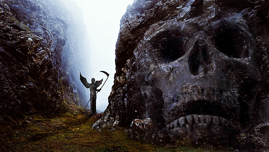 gray reaper standing between mountains thumbnail