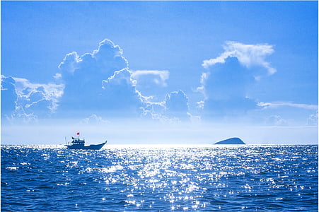 black vessel on body of water with blue sky background landscape photography thumbnail
