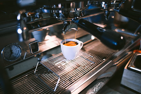 white ceramic coffee cup under espresso machine thumbnail