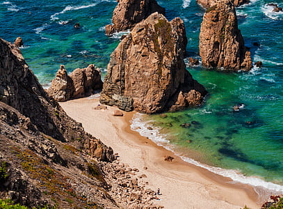 rock formation near seashore during daytime thumbnail