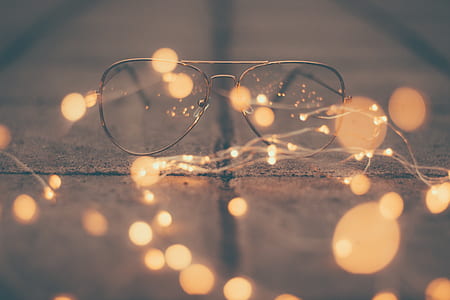 eyeglasses on floor with string lights thumbnail
