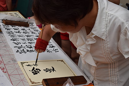 woman writing on yellow paper thumbnail