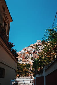 alley pathway overlooking assorted-color houses under blue daytime sky thumbnail