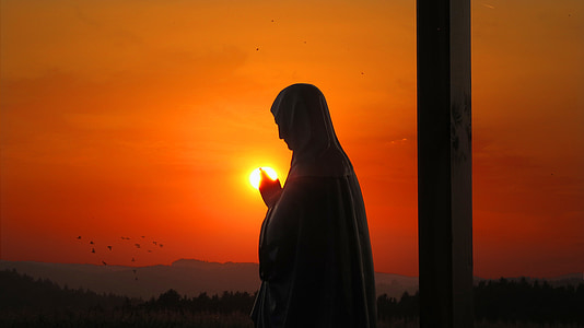 silhouette photo of female statue during golden hour thumbnail