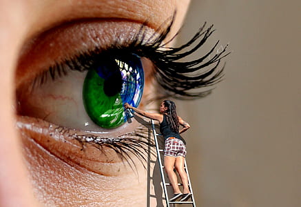macro shot of woman painting the green eye thumbnail