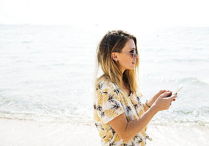 Girl on the Beach using Mobile phone thumbnail