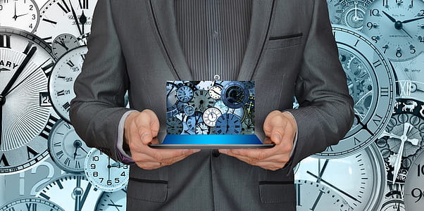person holding blue and green gear clock thumbnail