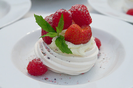 vanilla with strawberry and raspberry toppings on round white ceramic plate thumbnail