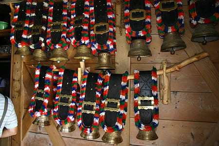 hanging bells on wooden wall racks thumbnail